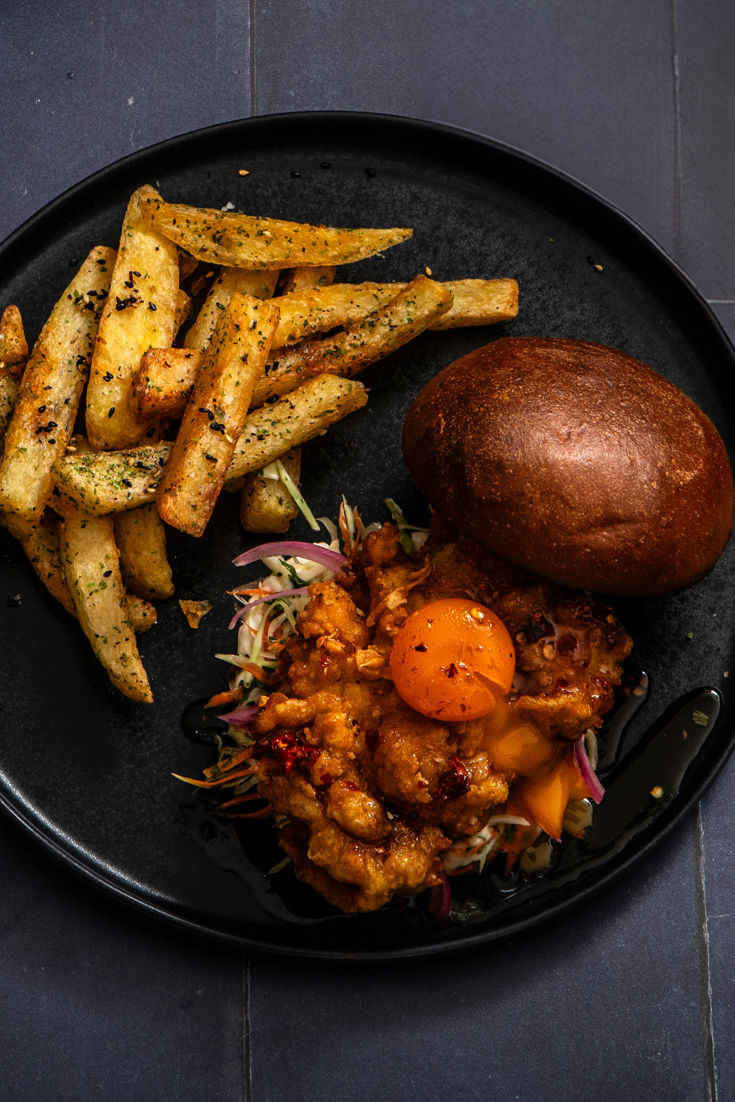 Buttermilk fried chicken sandwich with hot honey cured egg yolk and furikake chips Great