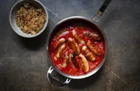 Lamb sausages in tomato sauce with bacon sauerkraut