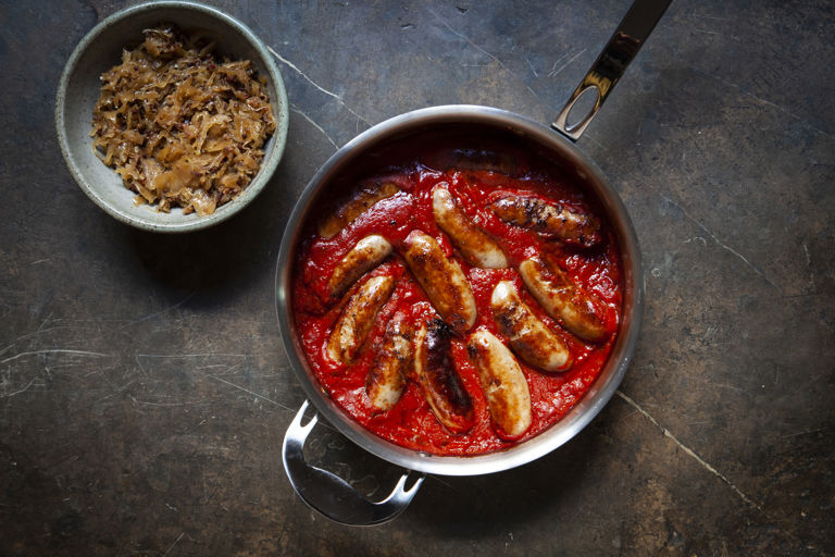 Lamb sausages in tomato sauce with bacon sauerkraut