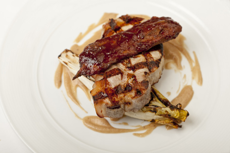 Barbecued pork chop with apple and endive