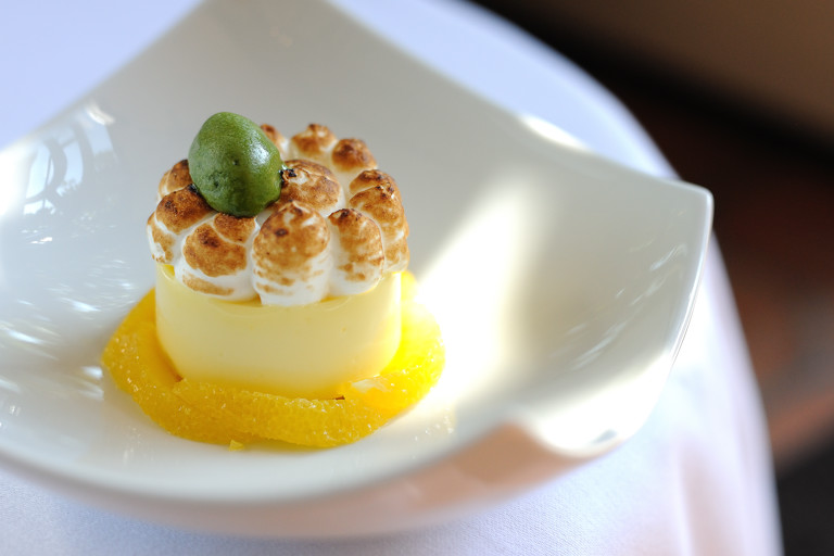 Lemon meringue pie with poached oranges and basil