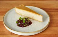 Baked vanilla halva cheesecake with bilberry compote