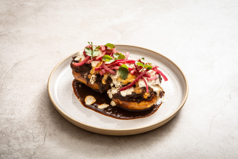 Beef birria-loaded jacket potatoes with lime crema