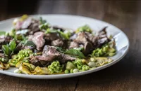 Barbecued lamb leg with courgettes, peas, broad beans, kohlrabi and fennel