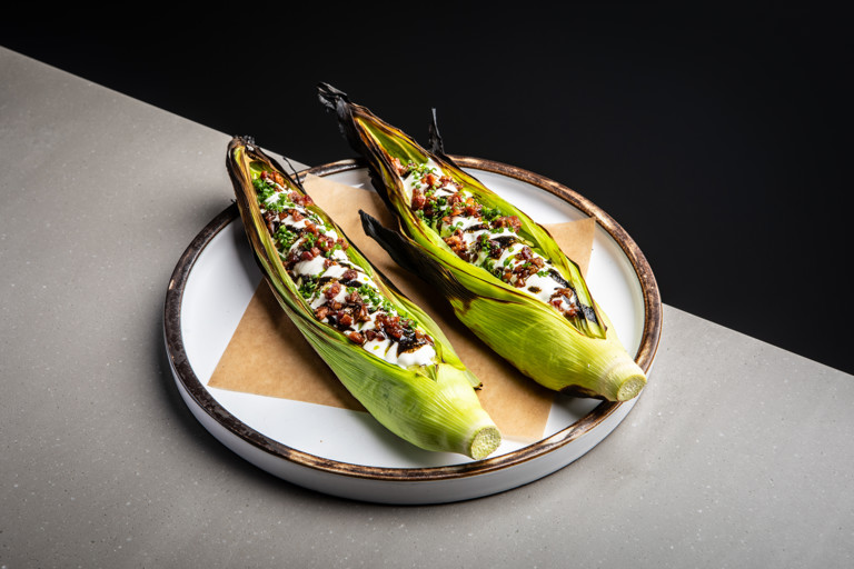 Barbecued baby corn with sour cream, bacon and chives