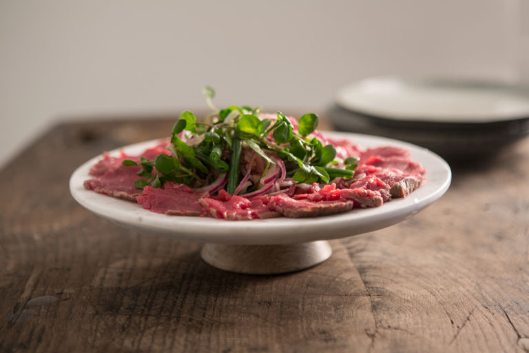 Carpaccio of beef with a sweet and sour onion and green bean salad