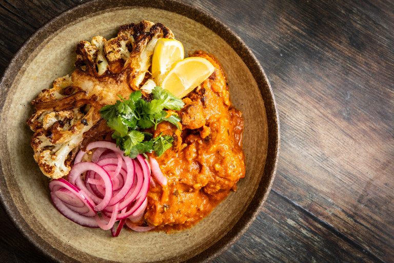 Chicken and black garlic madras with cauliflower and tamarind-coconut rice