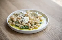 Braised butter beans with wild garlic and goat's curd