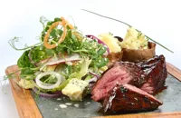 Organic chargrilled hanger steak, loaded potato skins, baby gem and blue cheese salad