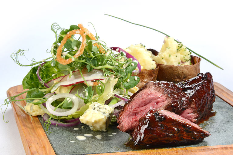 Organic chargrilled hanger steak, loaded potato skins, baby gem and blue cheese salad