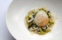 Slow-cooked duck egg with duck confit, asparagus and cobnuts