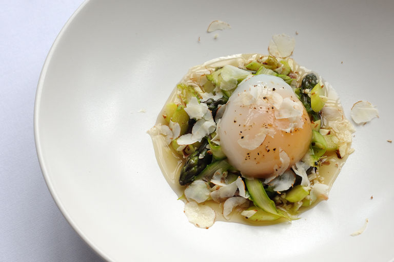 Slow-cooked duck egg with duck confit, asparagus and cobnuts