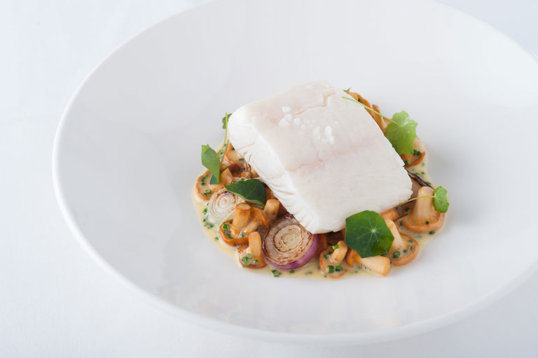 Vin jaune poached halibut with girolles and grilled grelot onions
