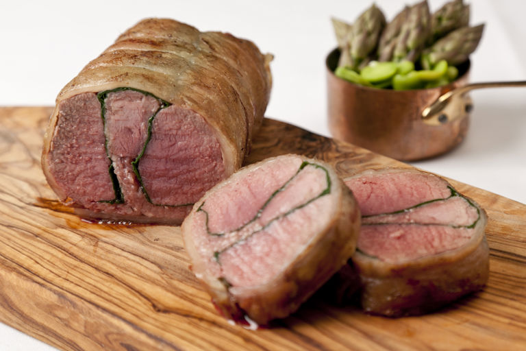 Roast whole saddle of lamb with spinach and black pudding