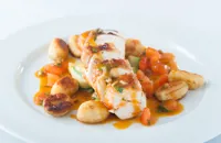 Breast of chicken with potato gnocchi, courgette ribbons and a tomato and olive sauce