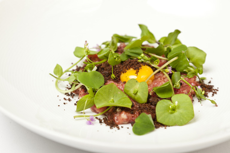 Veal tartare with dark malt crumble, wild herbs and quail eggs