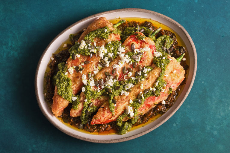 Chile rellenos with salsa roja, salsa verde, and toasted pumpkin seeds