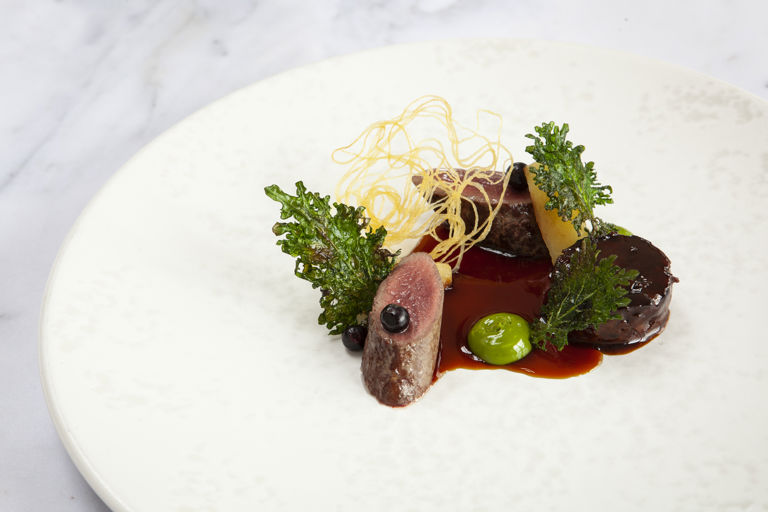 Hare with poached quince, kale and pickled blackcurrants