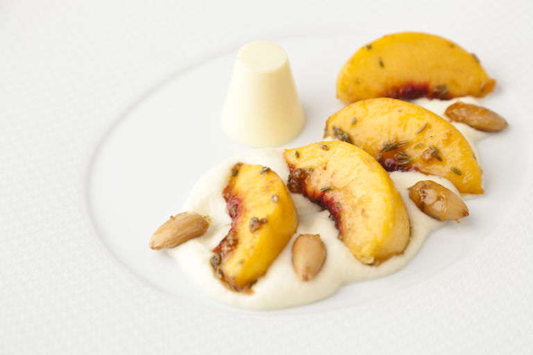 Grilled peaches, white chocolate rabdi and cardamom panna cotta