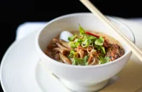 Duck and coconut laksa with grilled sweetcorn, soba noodles, squid and coriander
