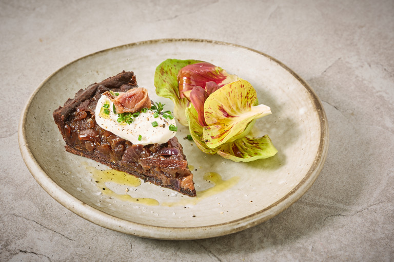 Caramelised red onion, anchovy and cocoa tart