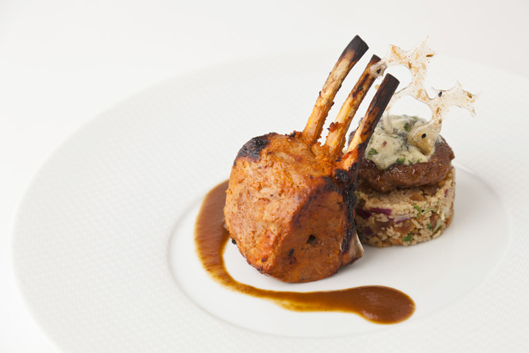 Home-smoked lamb rack with lamb jus, apricot-walnut couscous, blue cheese-lamb tikki