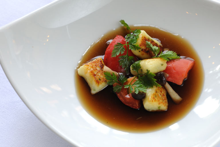 Wild mushroom consommé with herb gnocchi, confit tomatoes and pickled mushrooms 