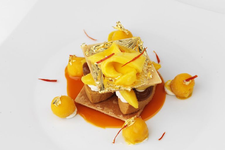 Caramel mille feuille, mango and gold leaf press and crystalised chilli