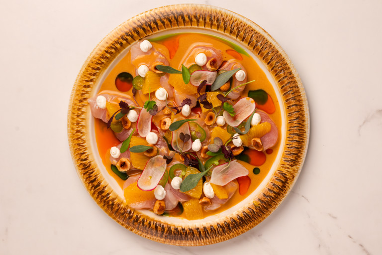 Kingfish tiradito with shellfish leche de tigre, amarillo shellfish oil, orange, hazelnuts and labneh