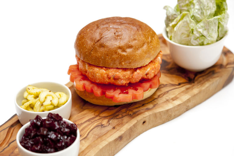 Alaska salmon burger with beetroot chutney, dill pickles and salad with sour cream dressing