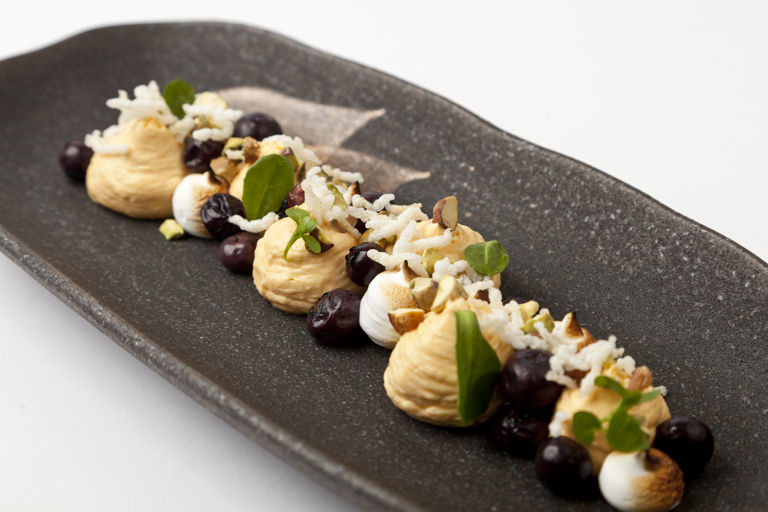 Whipped sea buckthorn with burnt meringue, crispy rice, blueberries and tonka bean gastrique