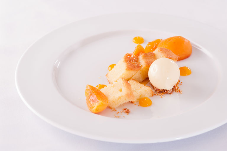 Poached apricots with almond sponge, apricot gel and clotted cream ice cream