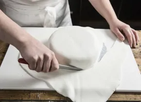 Use a sharp knife to trim away the excess sugar paste