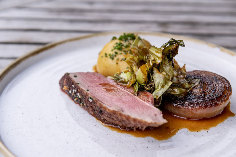 Duck with sauerkraut potato dumplings and hispi cabbage