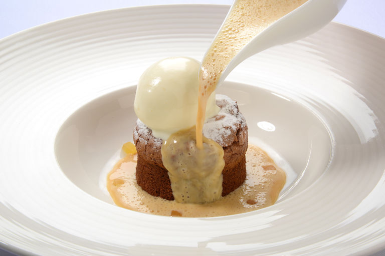 Melting ginger pudding with iced double cream and caramel custard