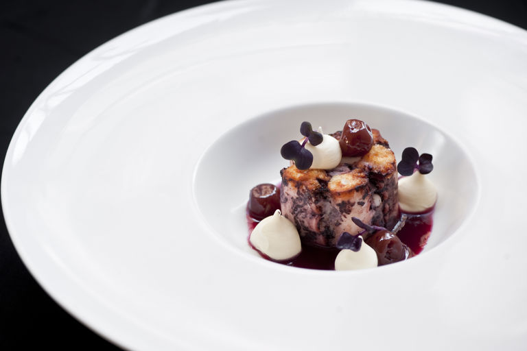 Braised octopus with sour cherries, sour cream and rosemary smoke