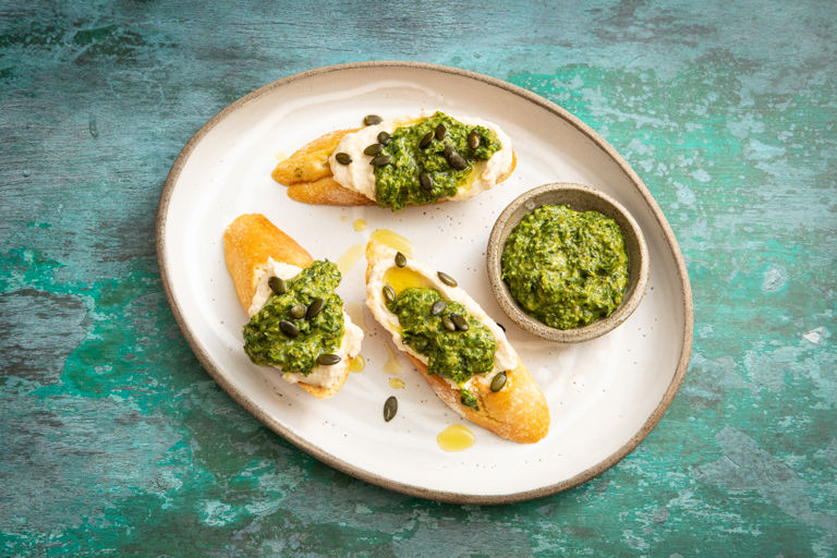 White bean crostini with mixed herb sauce and pumpkin seeds