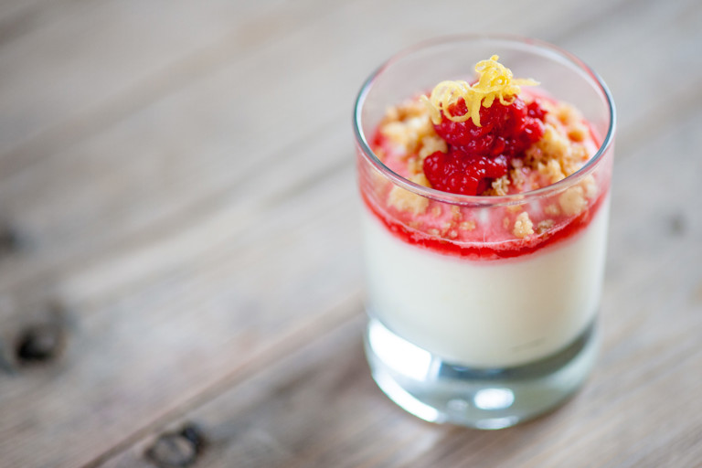 Lemon posset with raspberries and pine nuts