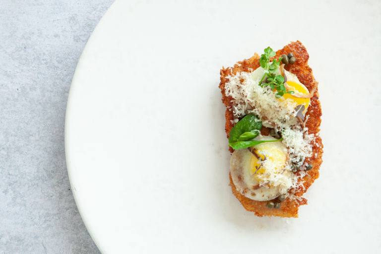 Pork schnitzel with Le Gruyère AOP, quail eggs, capers and anchovies