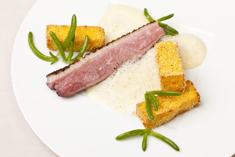 Duck breast with aromatic polenta fries and orange vinaigrette