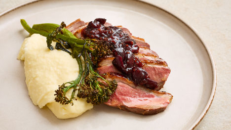 Duck breast with cherry hoisin sauce, pommes purée and charred broccoli