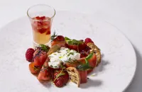 Tomato and berry salad with tomato water, watermelon and chives