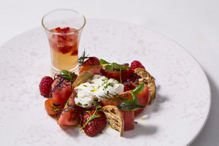 Tomato and berry salad with tomato water, watermelon and chives
