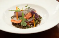 Pan-roasted fjord trout with lentils, crispy bacon and rocket leaves