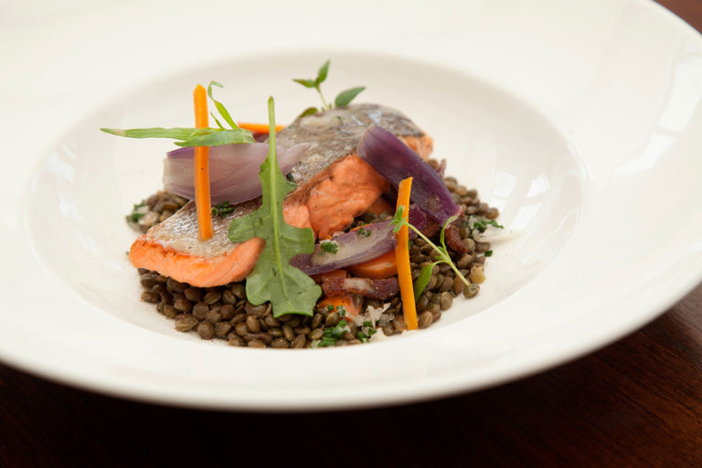 Pan-roasted fjord trout with lentils, crispy bacon and rocket leaves