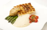 Crusted Alaska halibut with asparagus, confit tomatoes and oyster beignet