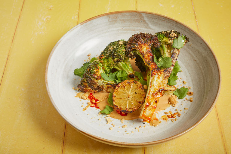 Barbecued broccoli with satay sauce, charred lime, toasted peanut, coriander