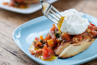 Plum tomato bruschetta with poached eggs