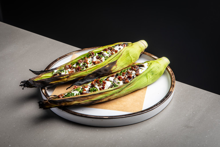 Barbecued baby corn with sour cream, bacon and chives