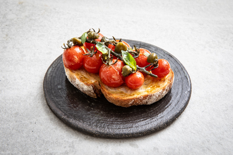 Confit Piccolo tomatoes on toast with anchovies and capers